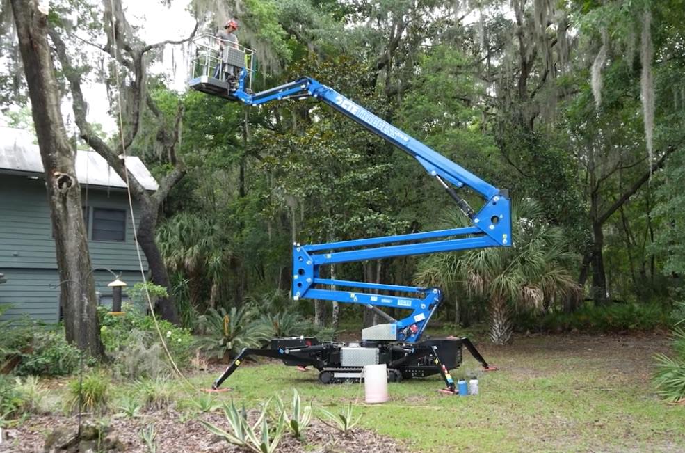 Tom Workman operating a CTE 270 spider lift for tree pruning service in Florida